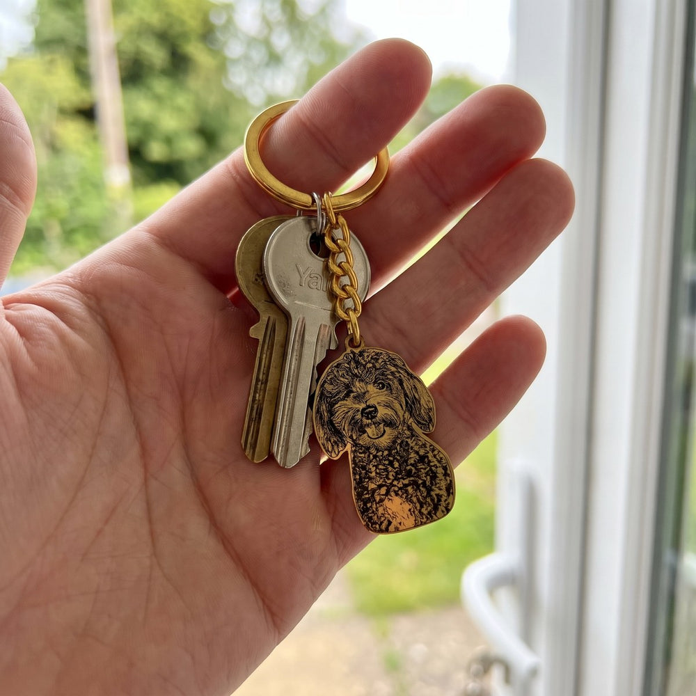 Gold engraved dog keychain on a set of house keys at the front door