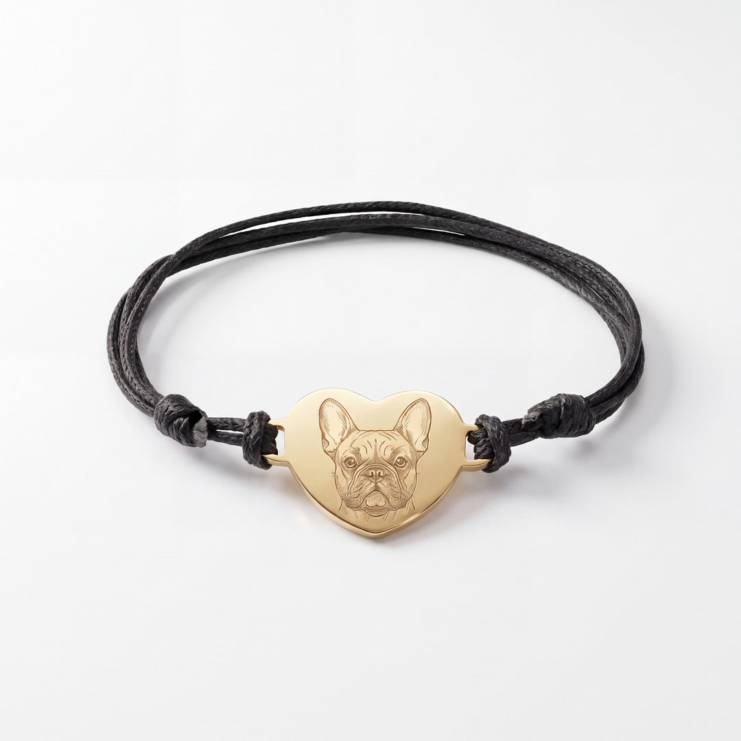 Black cord bracelet with a gold heart engraved with a French Bulldog line drawing