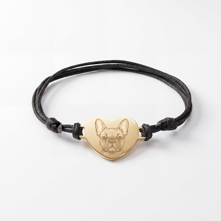 Black cord bracelet with a gold heart engraved with a French Bulldog line drawing