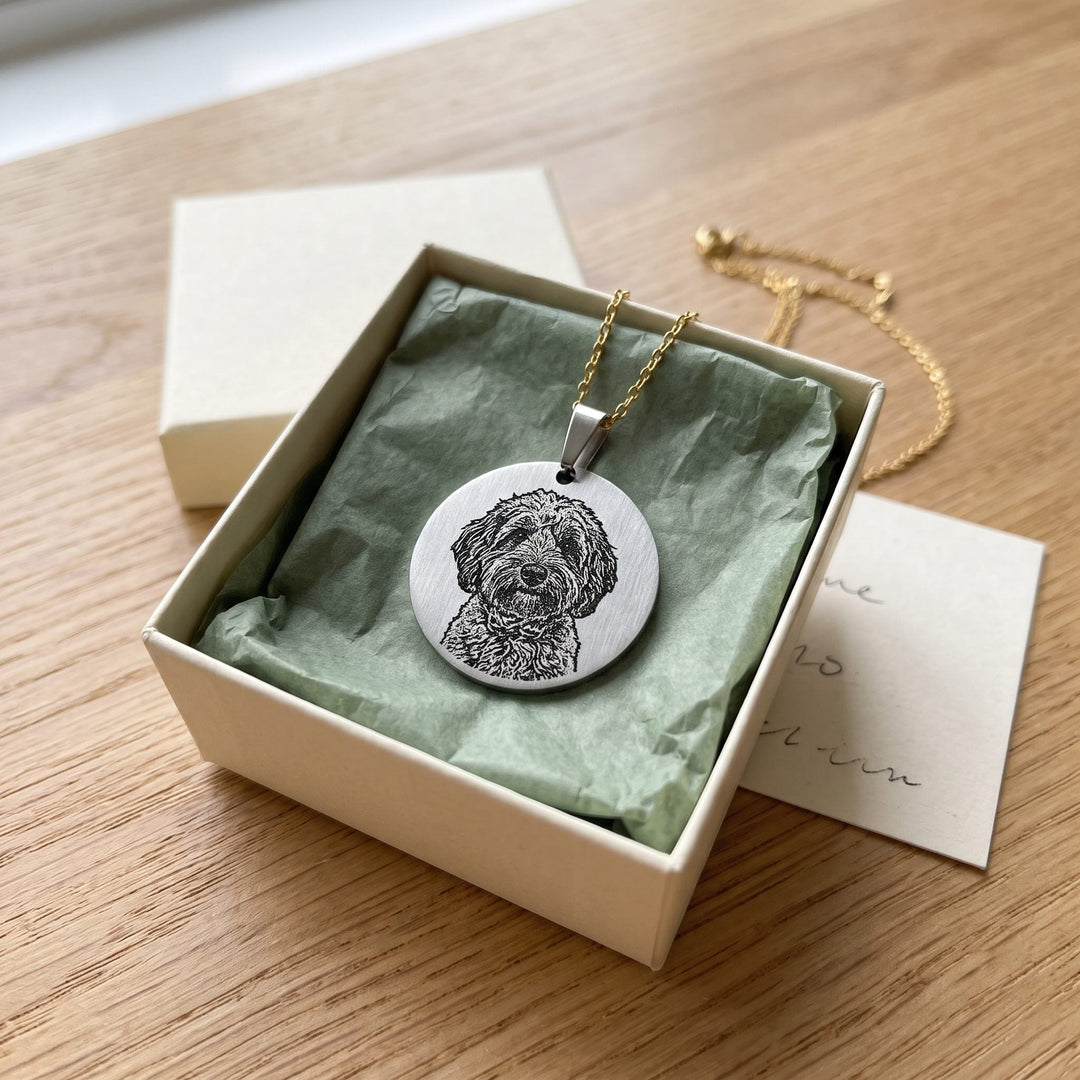 round pet photo necklace with an engraved pet portrait, in a gift box