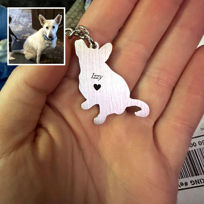 Customer's engraved keychain with Izzy's name, next to the photo of Izzy it was made from