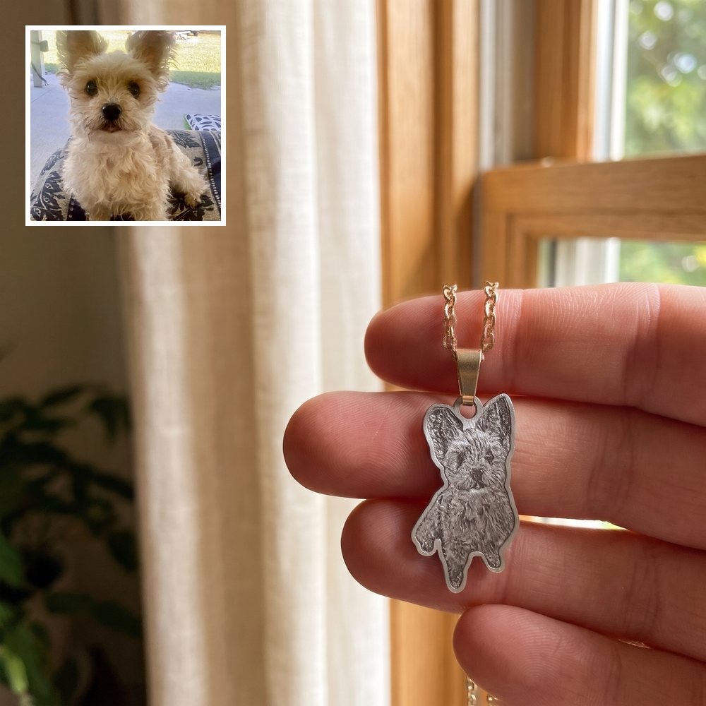 Angela's engraved pendant of Baylee, held in hand, with her photo of Baylee