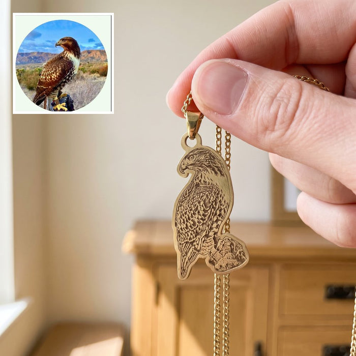 Gold necklace engraved with a hawk, with the customer's photo of the hawk