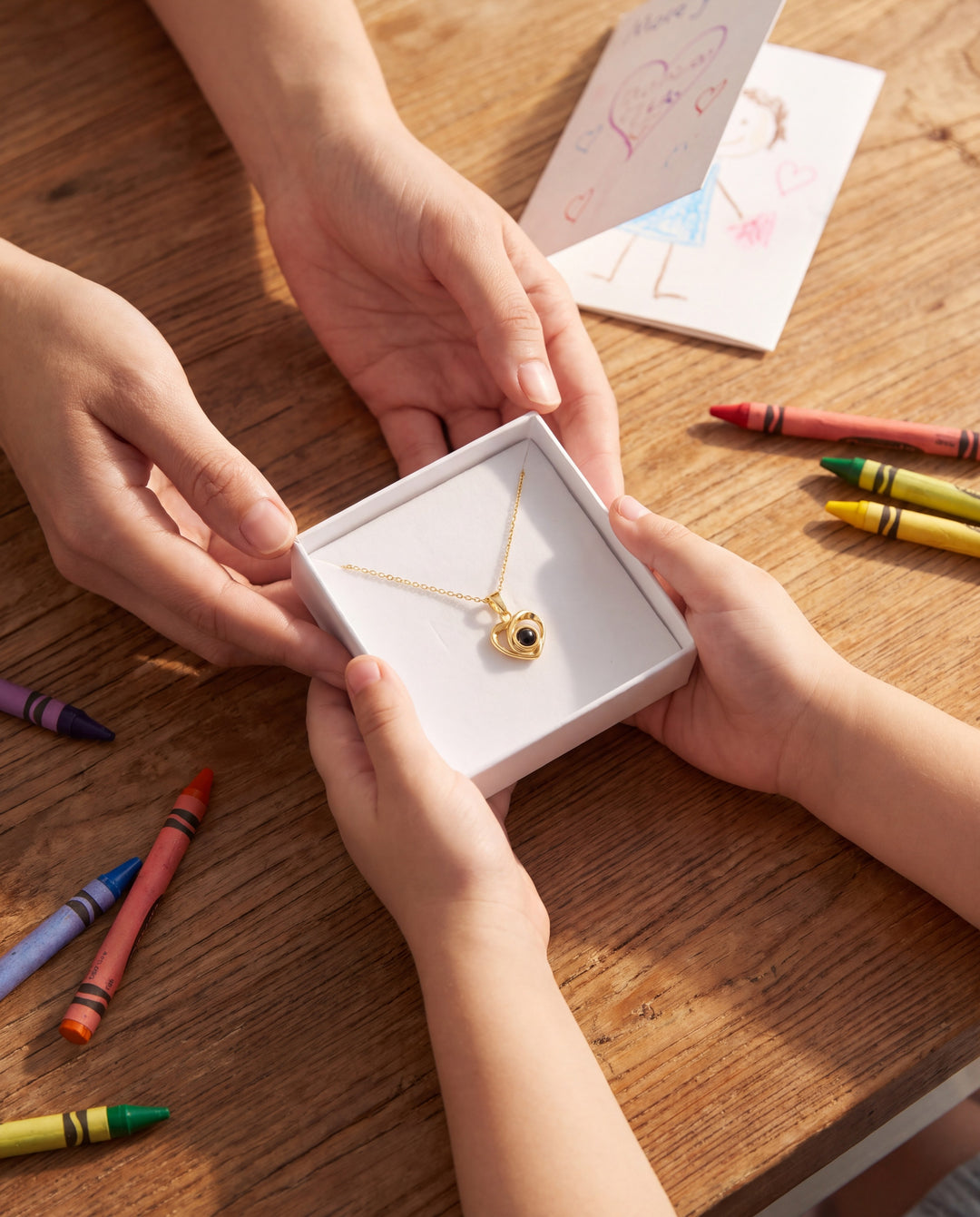 Child handing mom a gift box with a gold heart projection necklace