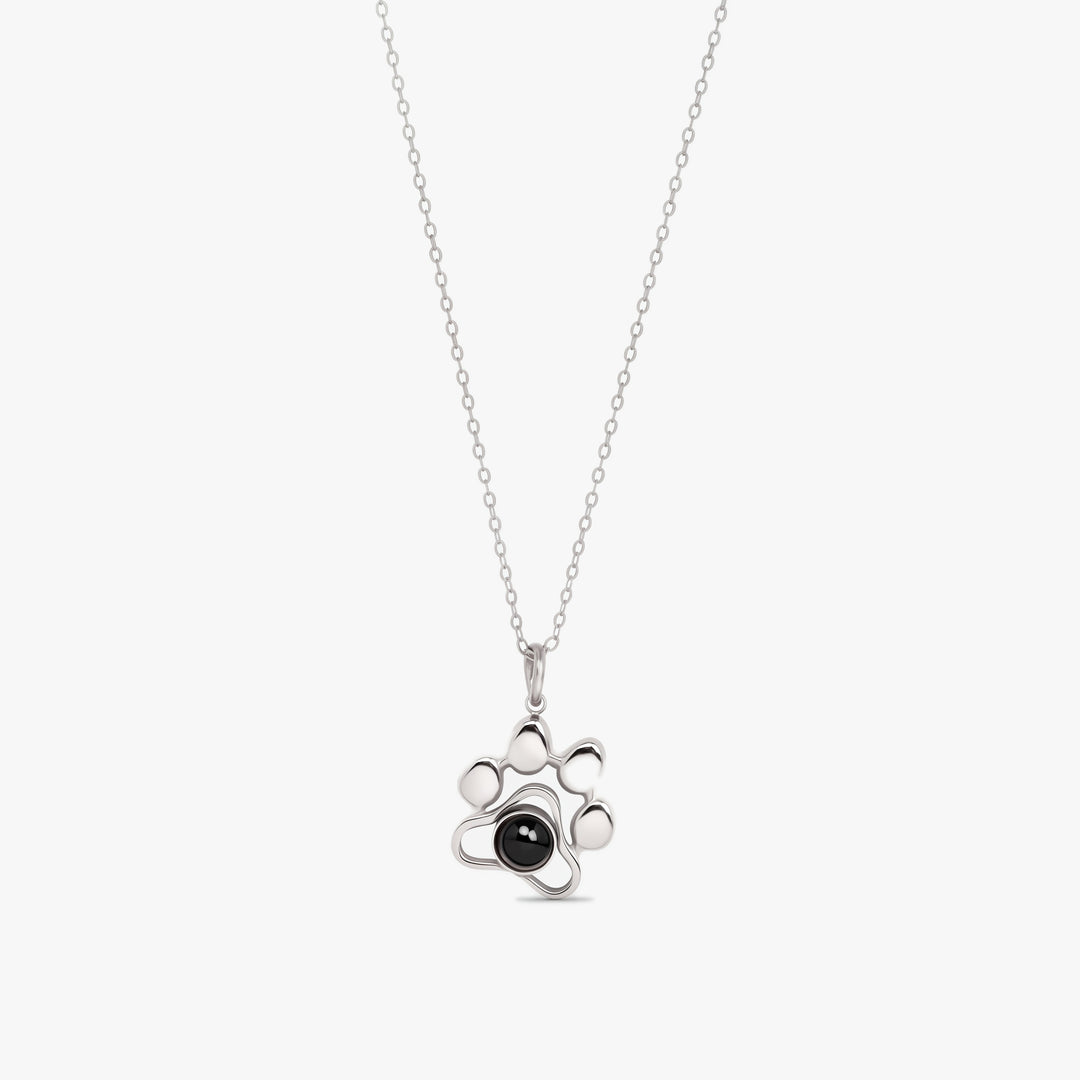 Silver paw print projection necklace with a photo stone in the paw