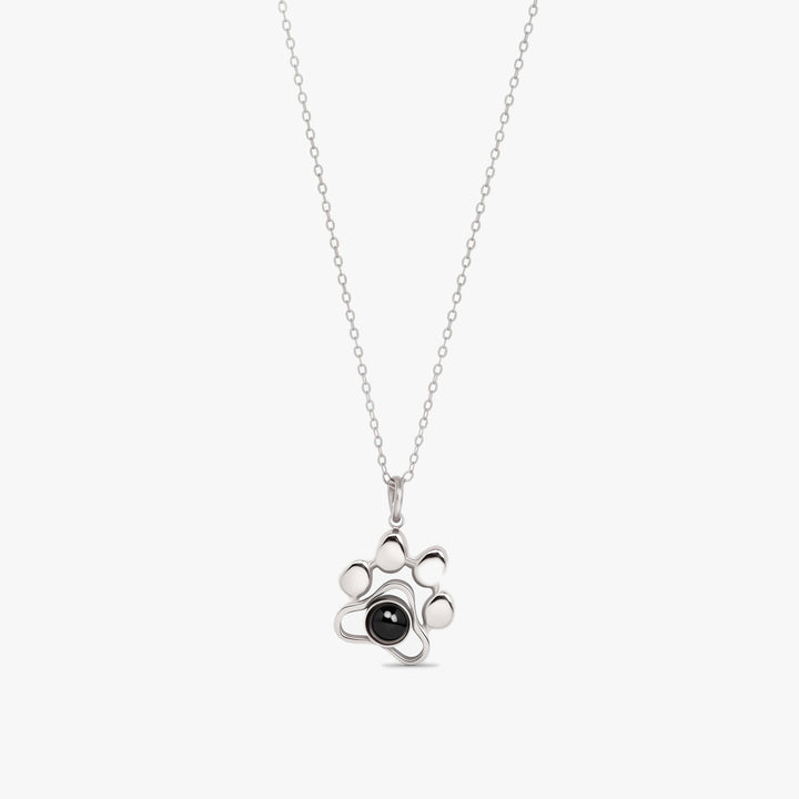 Silver paw print projection necklace with a photo stone in the paw