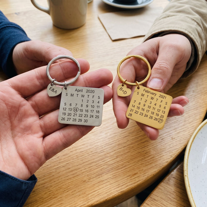 personalized calendar keychain with an engraved date, a couple holding matching pieces