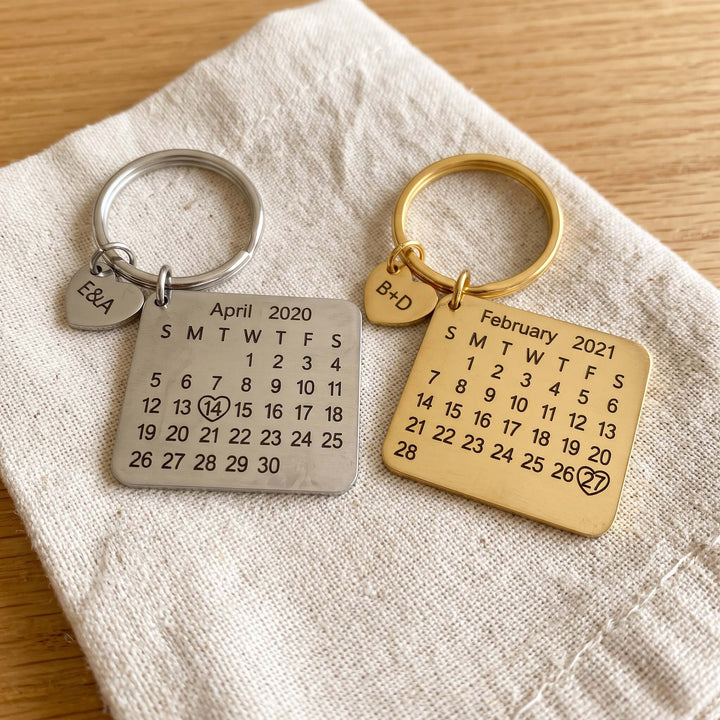 personalized calendar keychain with an engraved date, silver and gold side by side