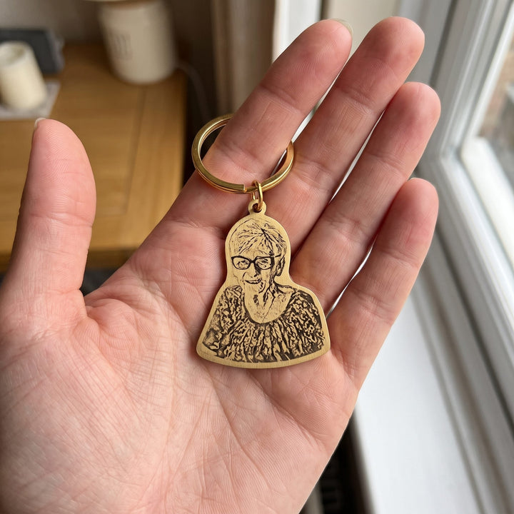 remembrance photo keychain engraved from a photo, held in a hand to show true size