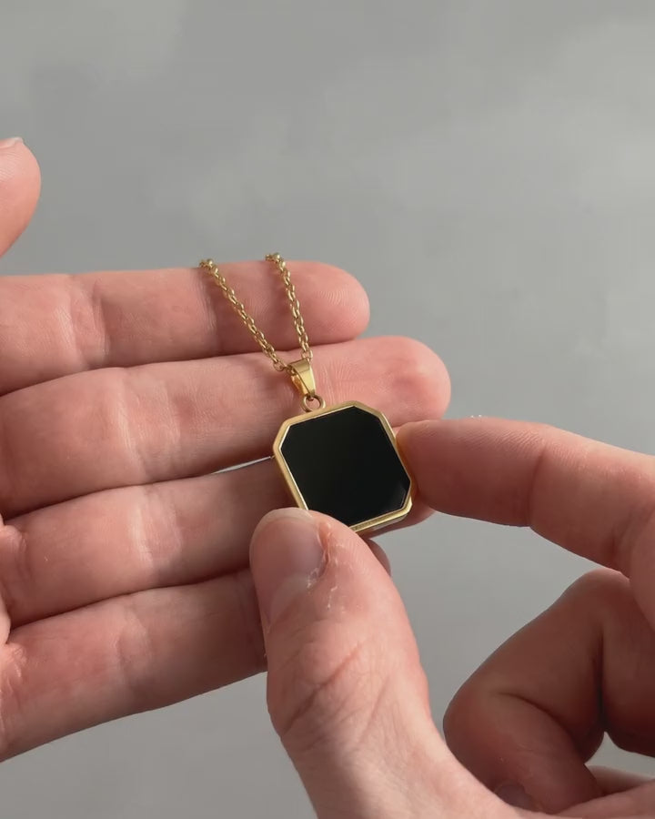 Thumb warms a black heat-activated pendant and a family photo appears