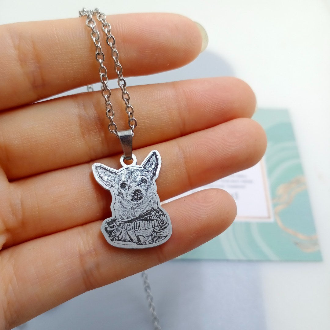 Real customer pet photo necklace with a chihuahua portrait, held in hand