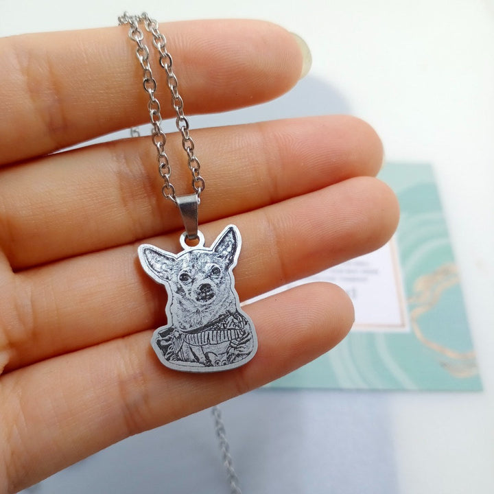 Real customer pet photo necklace with a chihuahua portrait, held in hand
